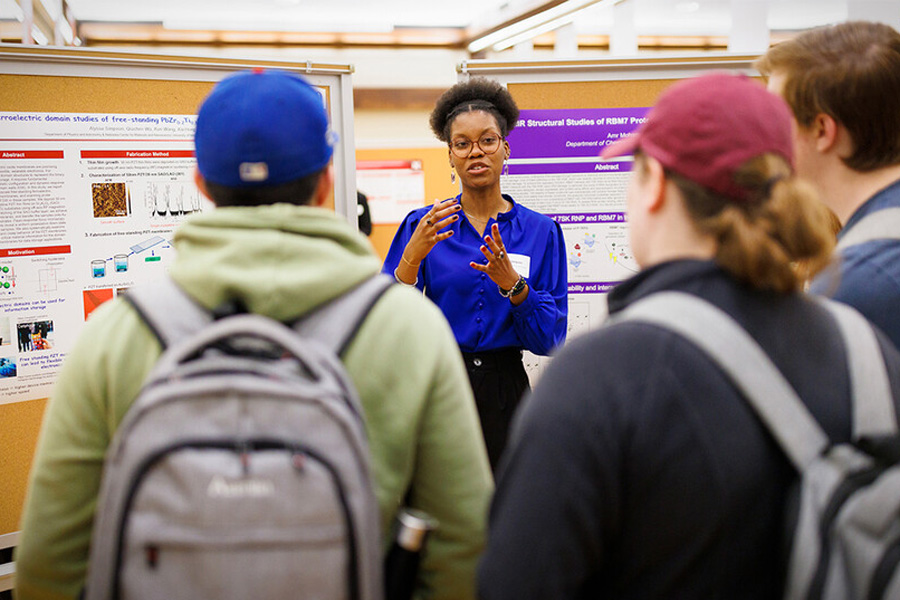 Alyssa Simpson explains research to other students