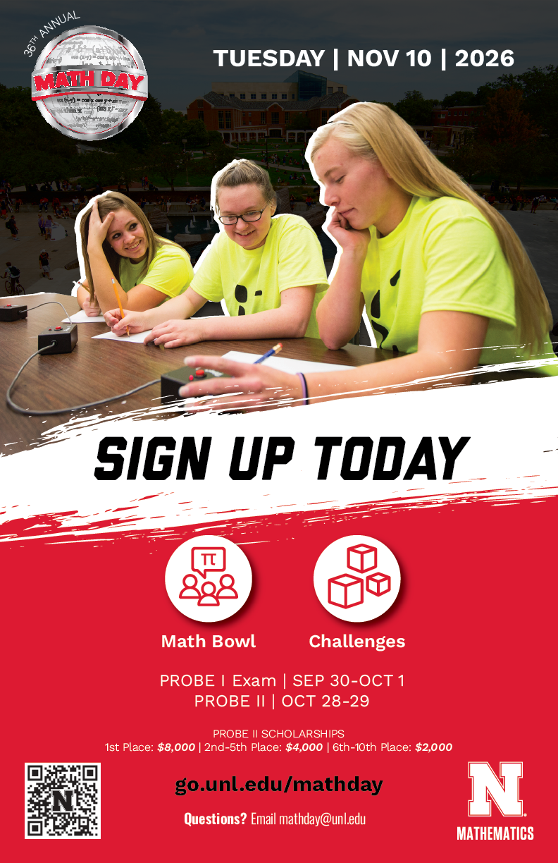 Students in bright yellow shirts work on math activities at a table outdoors.